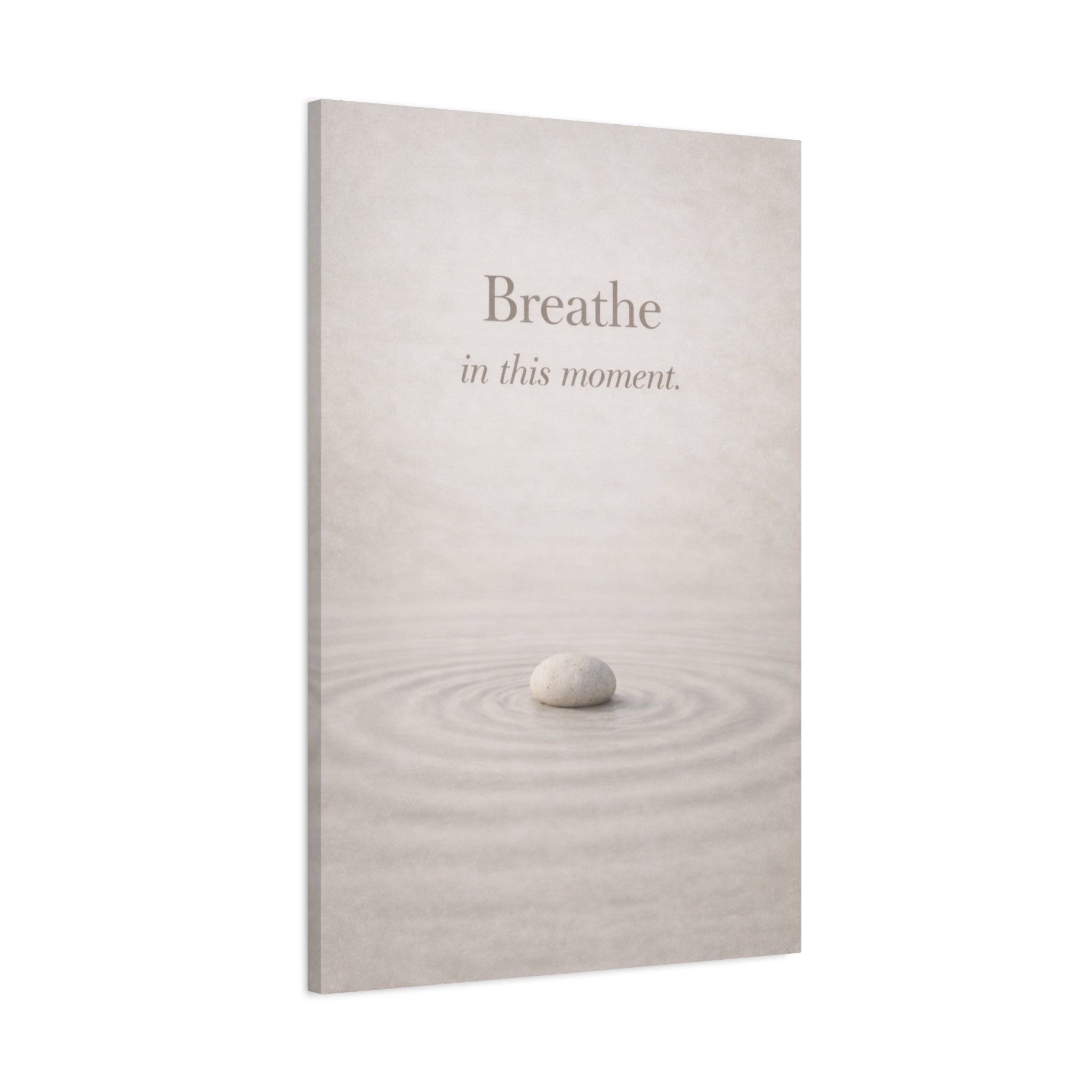 Zen mindfulness canvas wall art with a minimalistic design of a stone in water and the text 'Breathe in this moment' on a white background.