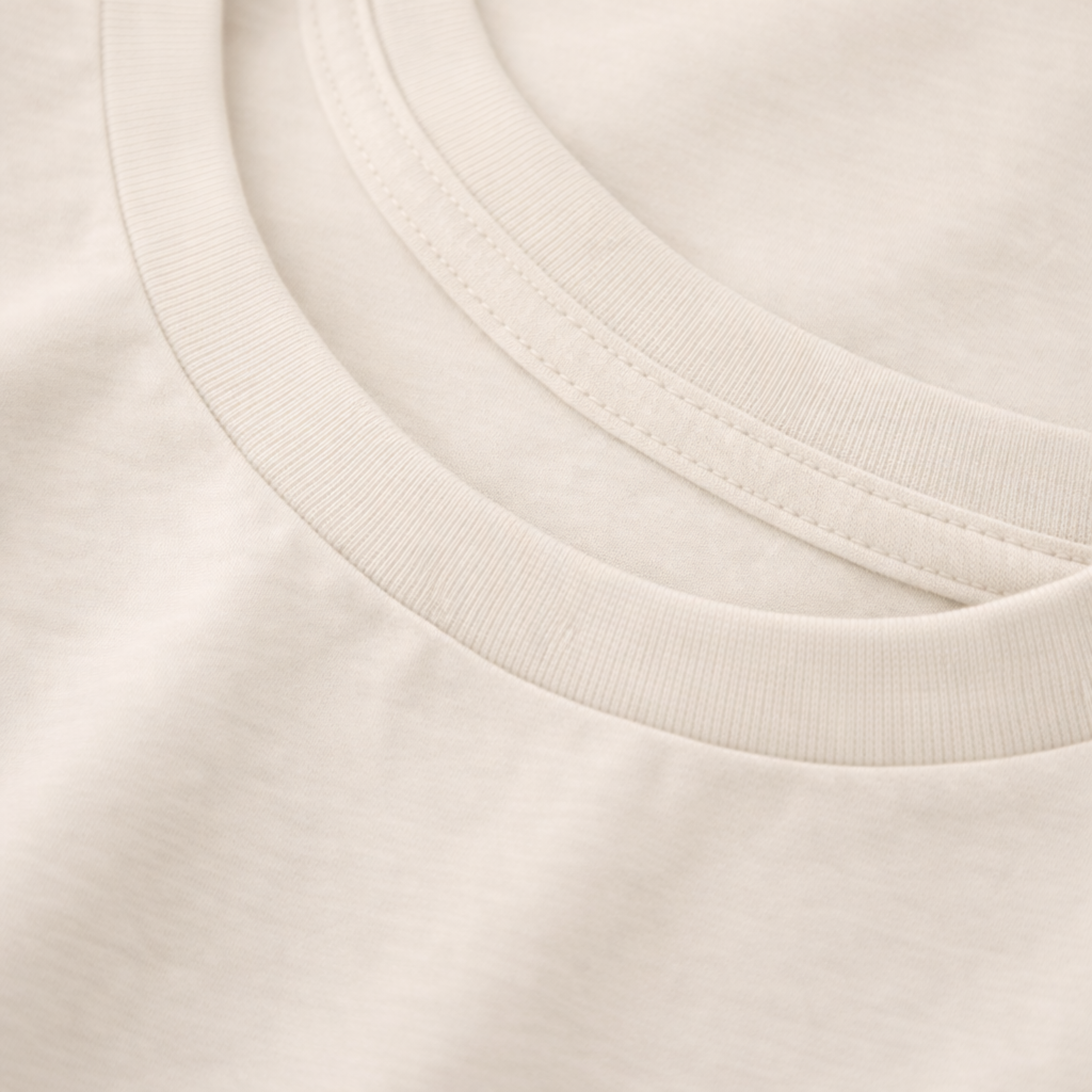 Close-up of a beige tee with a focus on the neckline.