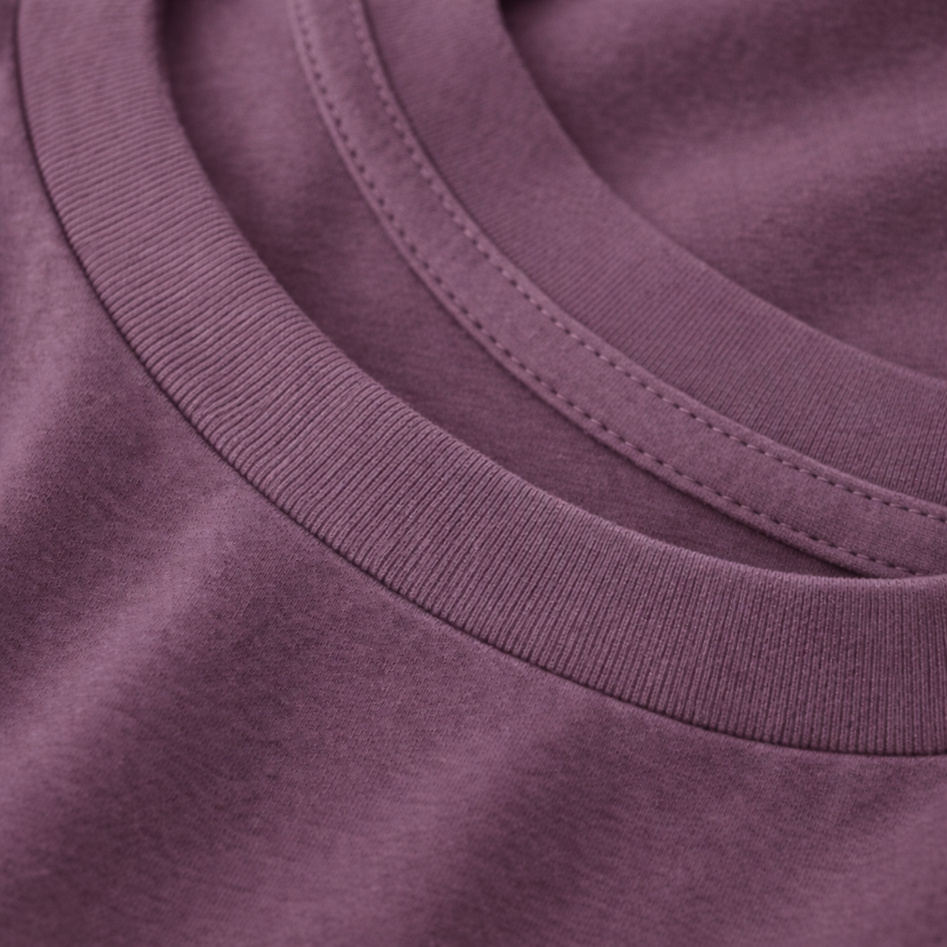Close-up of a purple tee with a focus on the neckline.