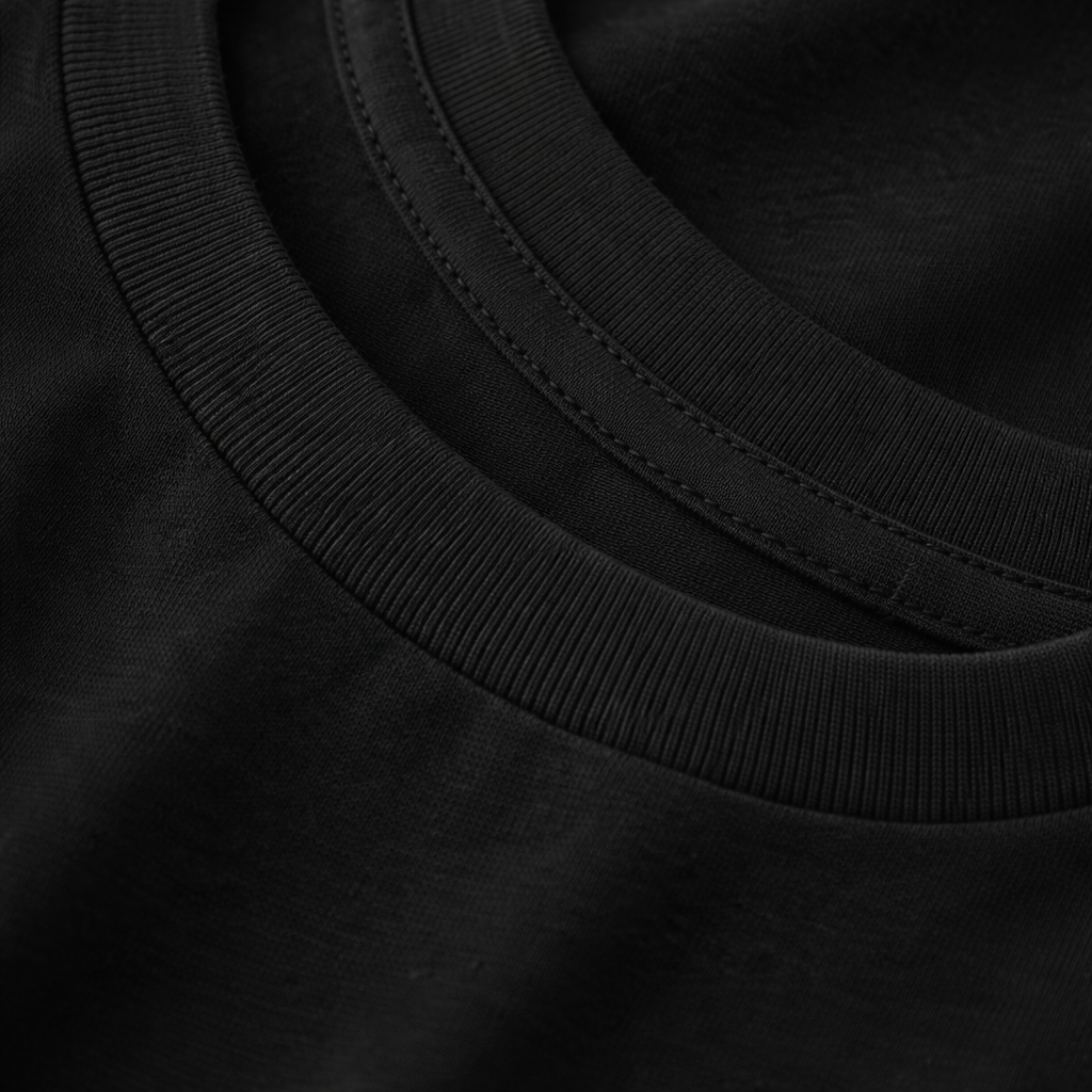 Close-up of a black tee collar with stitching detail