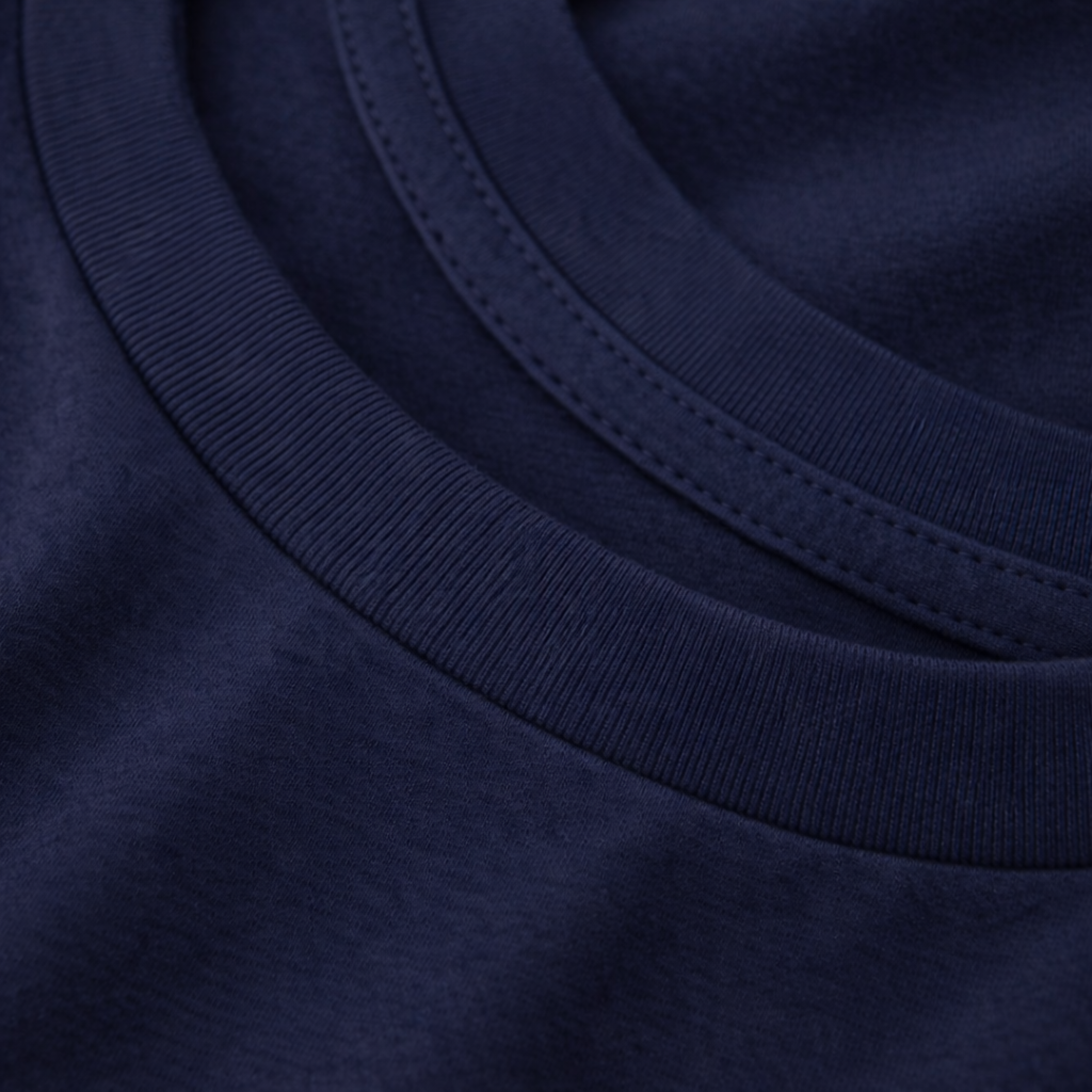 Close-up of a navy blue tee with a focus on the neckline.