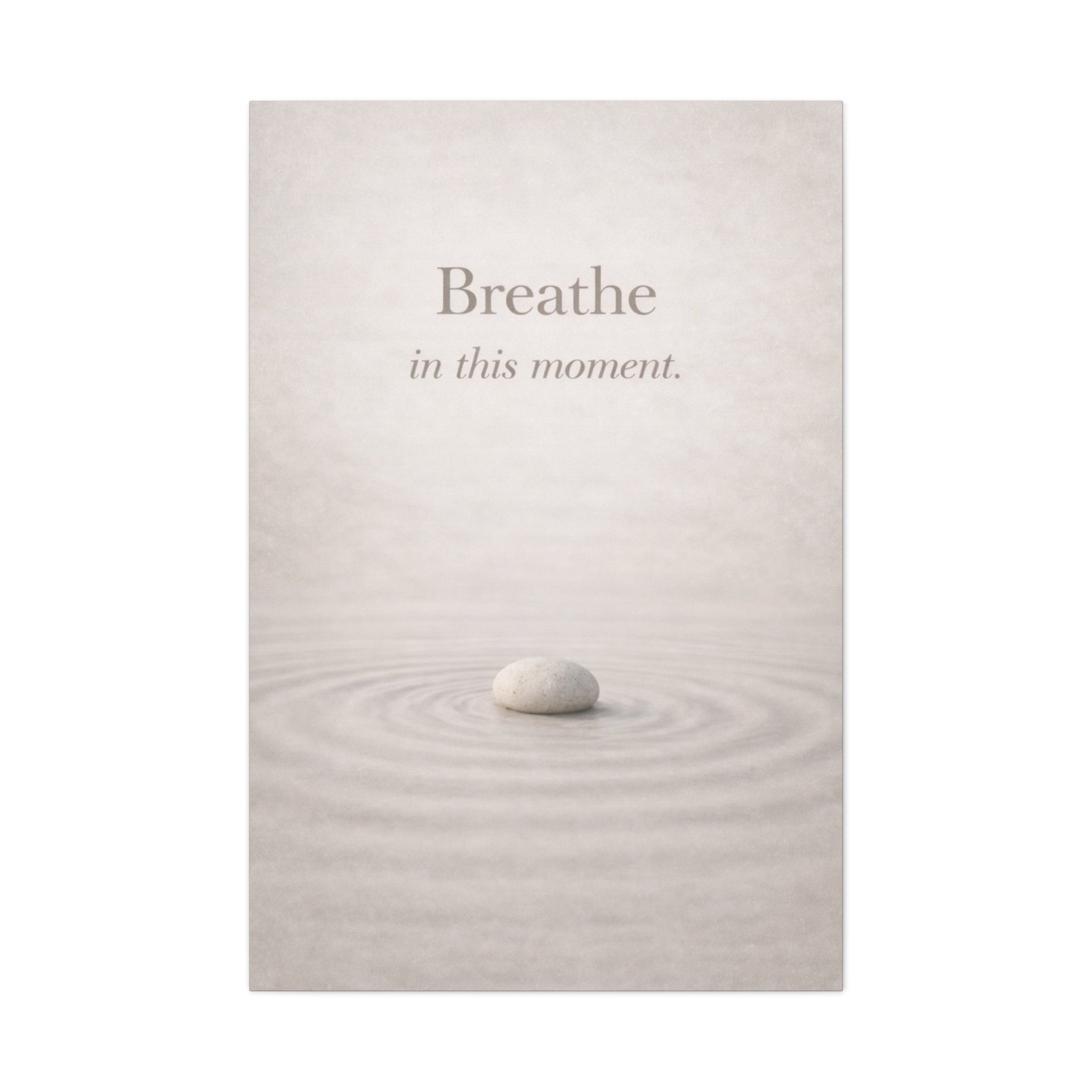 Rounded stone on water with 'Breathe in this moment' text on a light gray background. Zen mindfulness canvas wall art