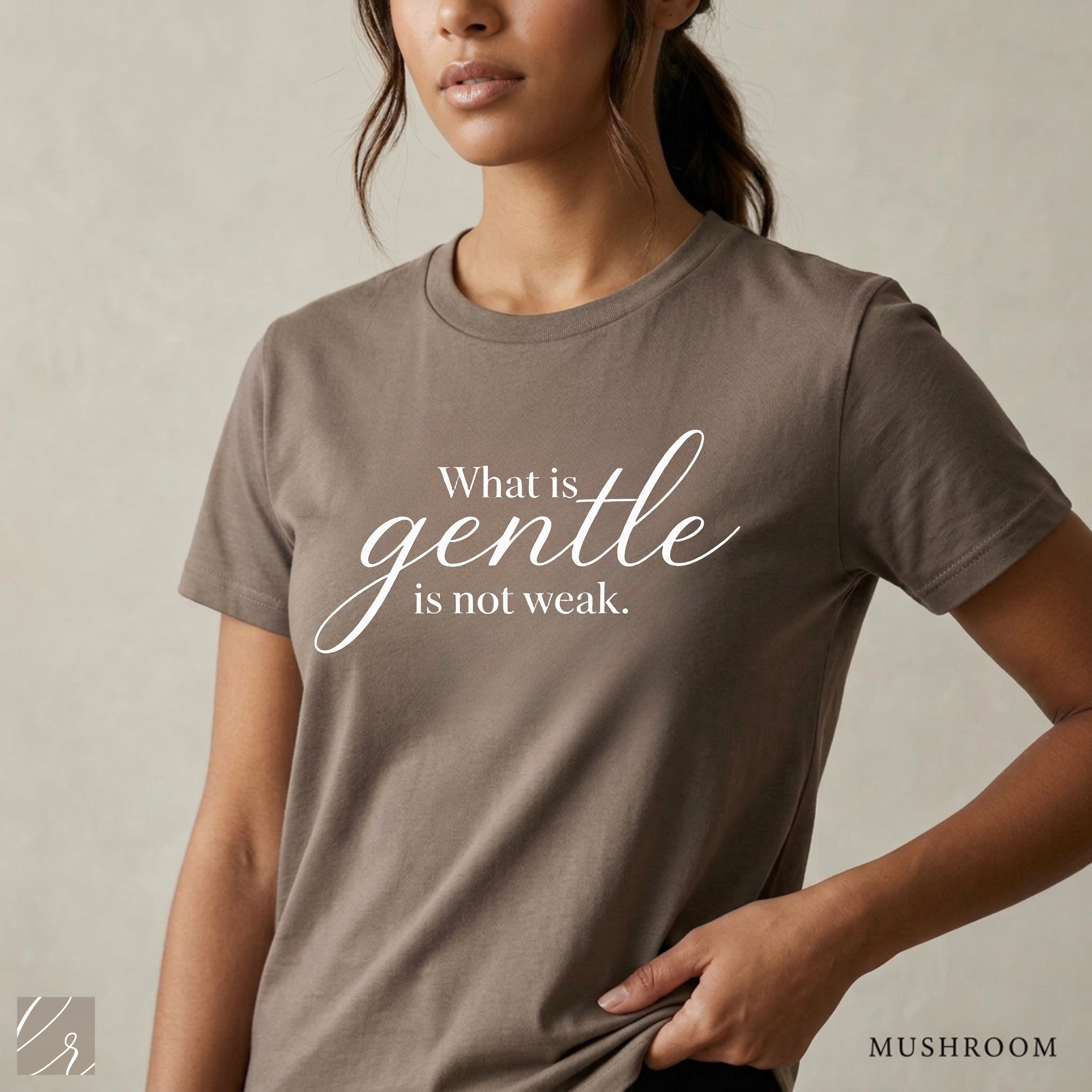 Close-up product photo of a women’s mushroom brown graphic tee with elegant white typography, shown on a model in soft natural light with a clean neutral background and refined modern styling.