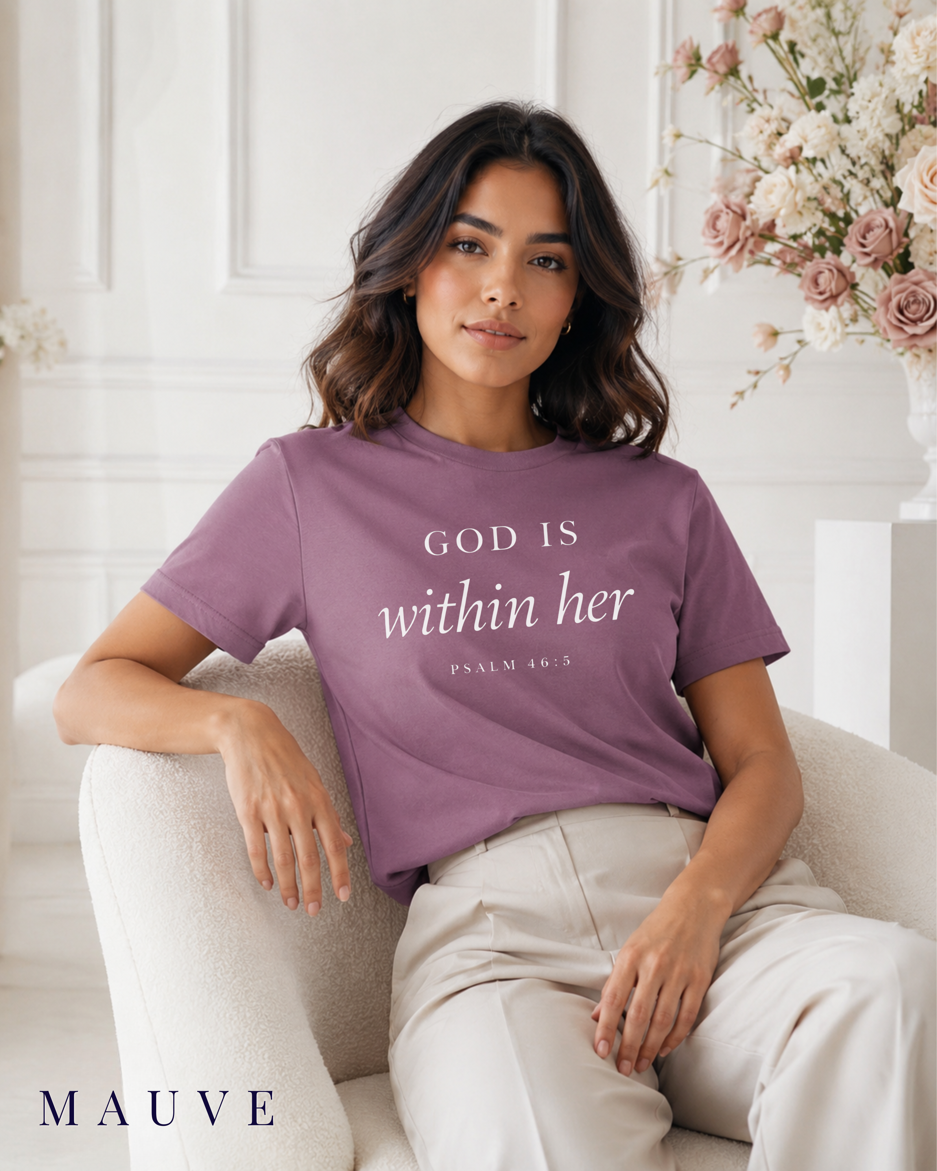 Mauve God Is Within Her Psalm 46:5 Christian graphic tee for women. A woman sits on a light beige armchair wearing a mauve short-sleeve graphic T-shirt. The word 'MAUVE' appears in the bottom left corner.