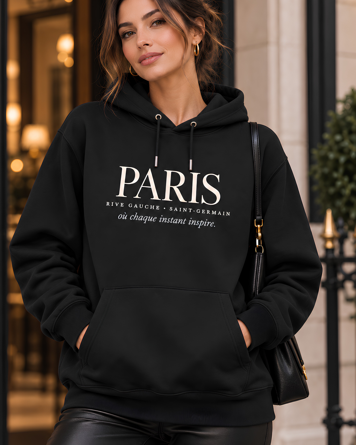 Black Paris Rive Gauche graphic hoodie for women styled in a casual city streetwear outfit.