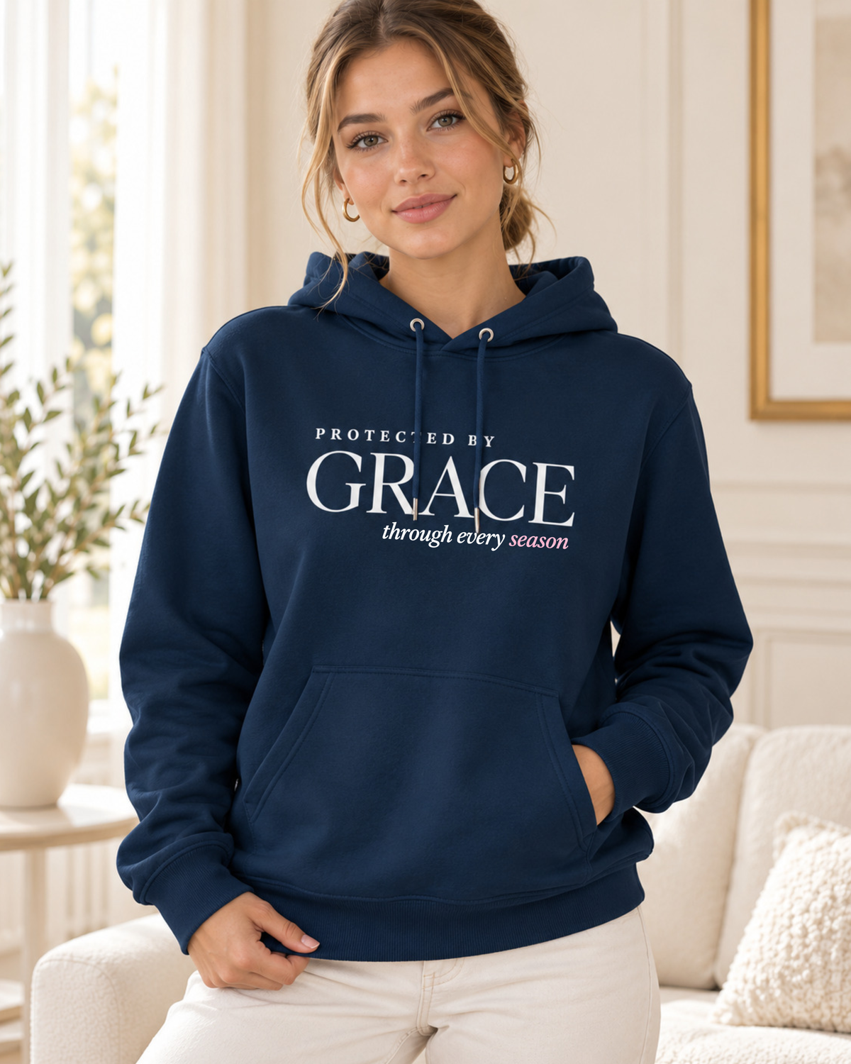 Protected by Grace women's pullover hoodie with front typography and kangaroo pocket.