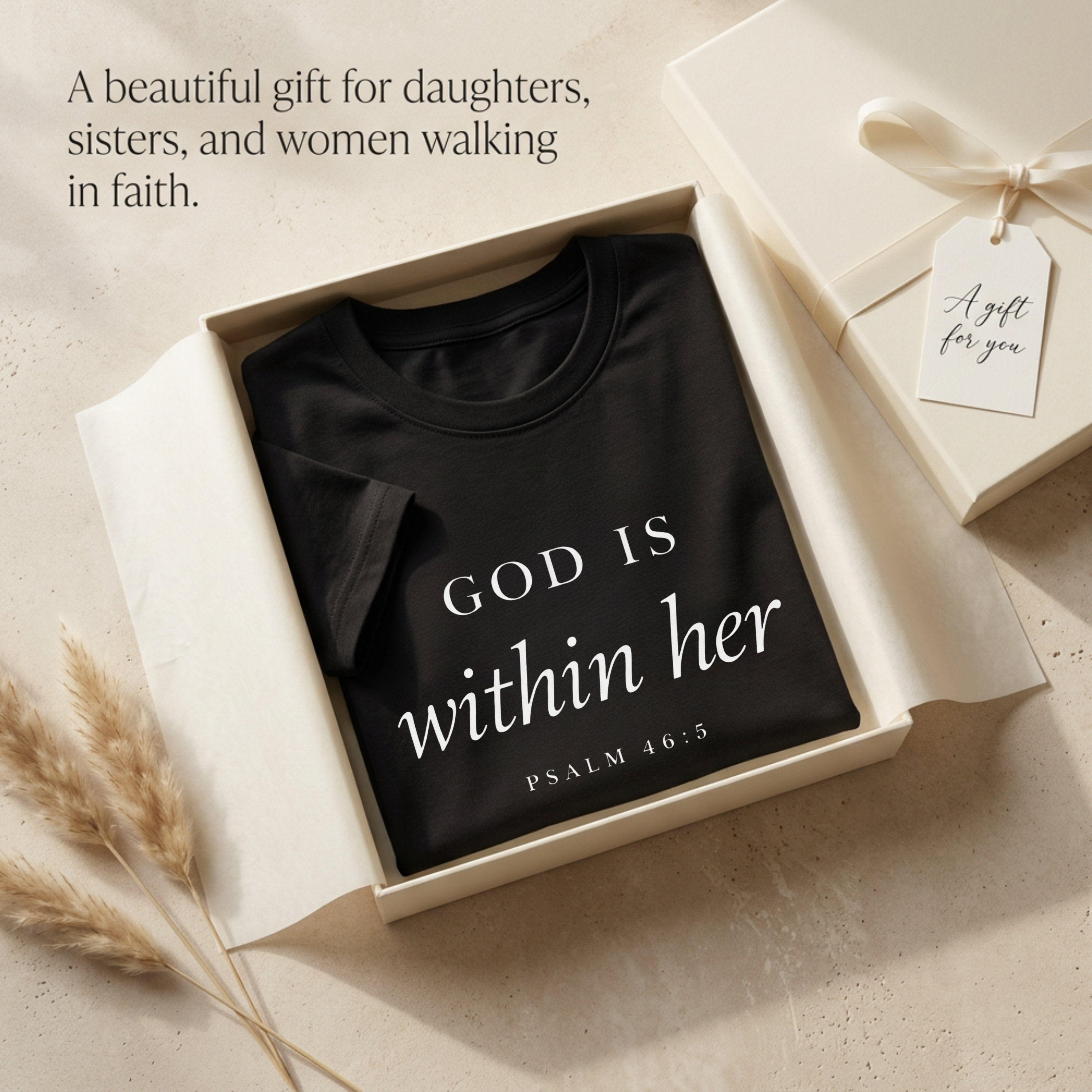 Gift for her shows God is within her Psalm 46:5 bible verse on a black T-shirt in a gift box. Title: A beautiful gift for daughters, sisters, and women walking in faith."