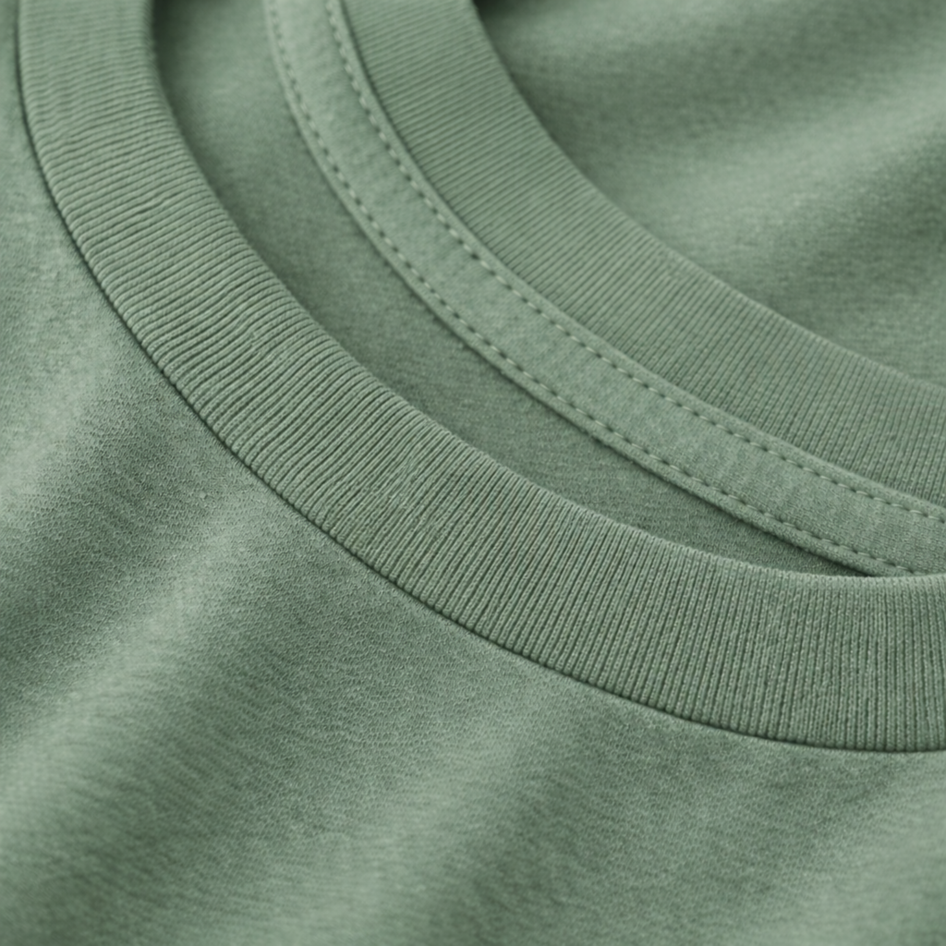 Close-up of a green tee with a focus on the neckline.