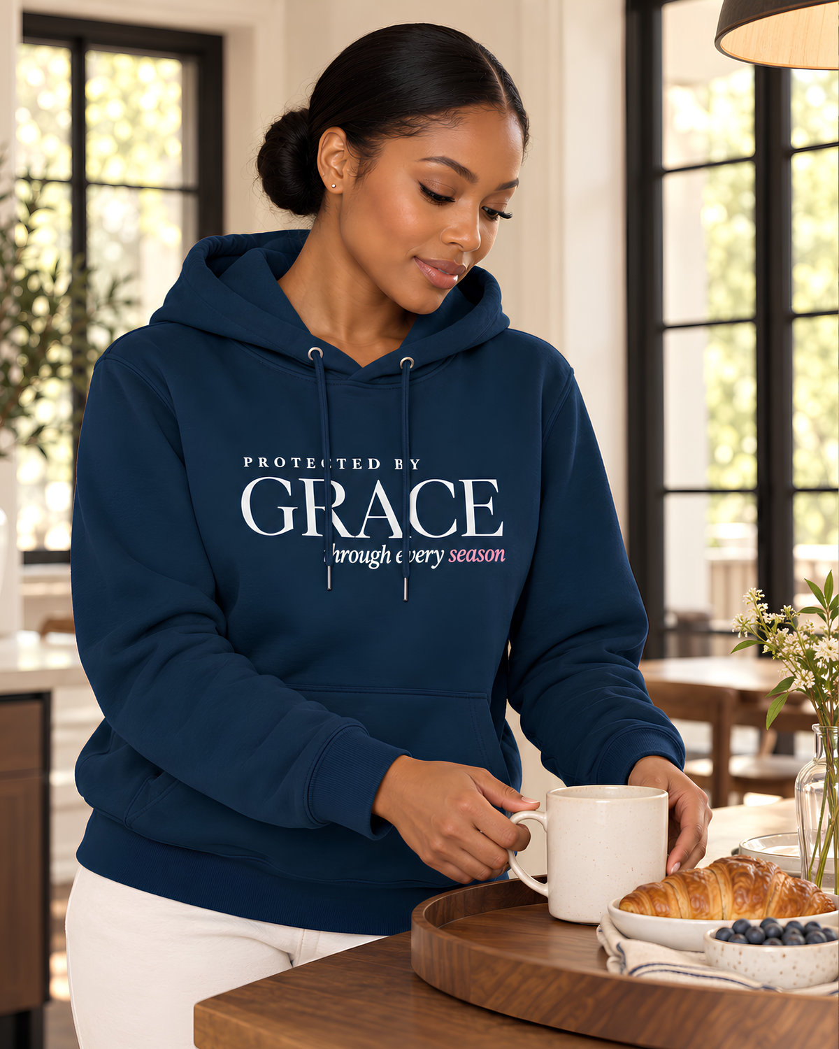 Navy Protected by Grace Christian hoodie for women showing the printed faith message and drawstrings.