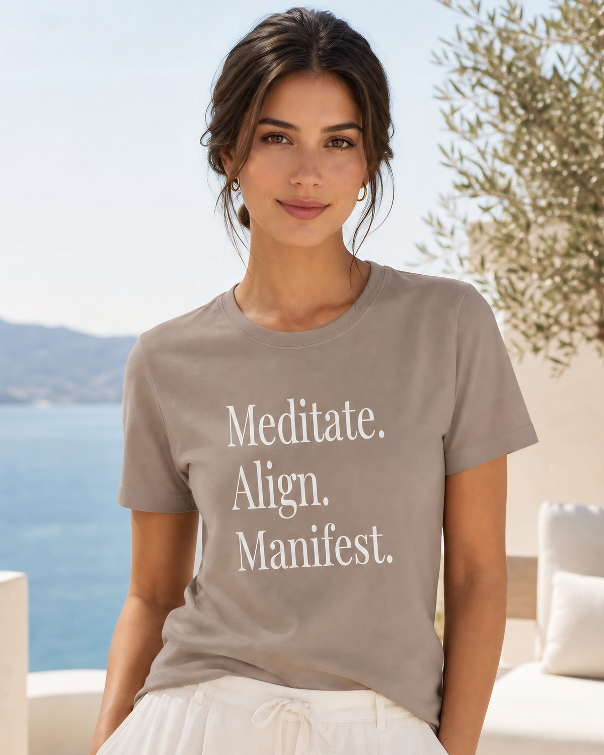 Women’s manifestation graphic tee in tan featuring “Meditate. Align. Manifest.” with a refined minimalist design, styled as an inspirational mindfulness and self growth shirt.