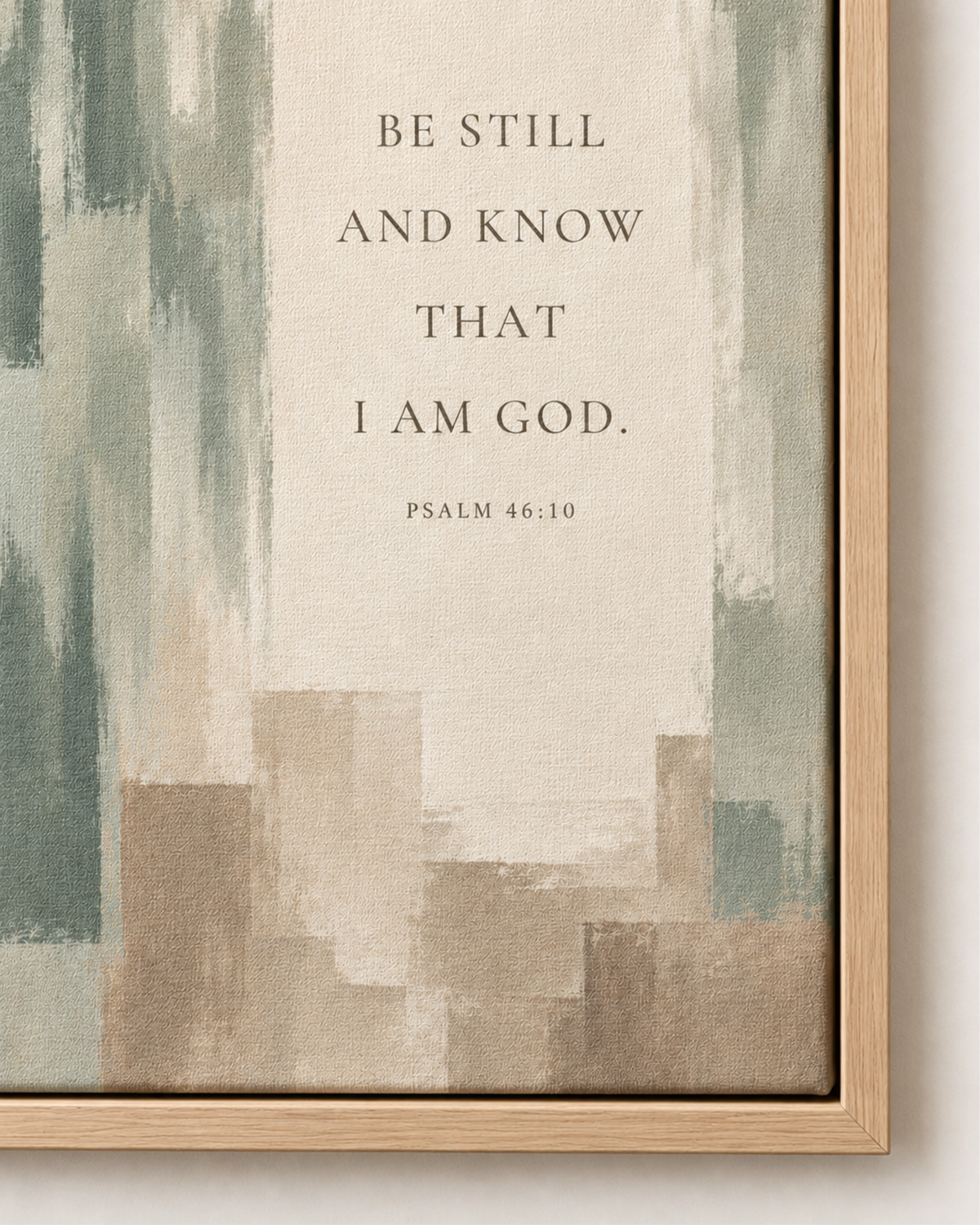 Close-up of Be Still and Know canvas wall art showing Psalm 46:10 lettering, muted sage brushwork, and natural frame