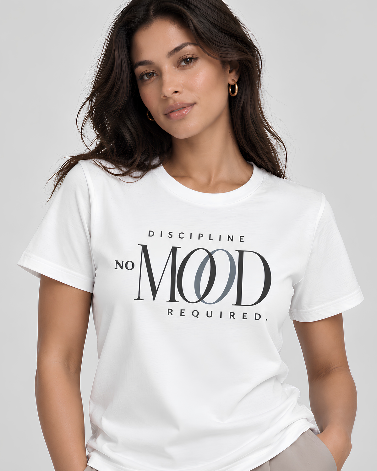 Woman wearing a white ‘Discipline No Mood Required’ graphic tee, a premium women’s motivational workout shirt for gym, Pilates, fitness and everyday wear.