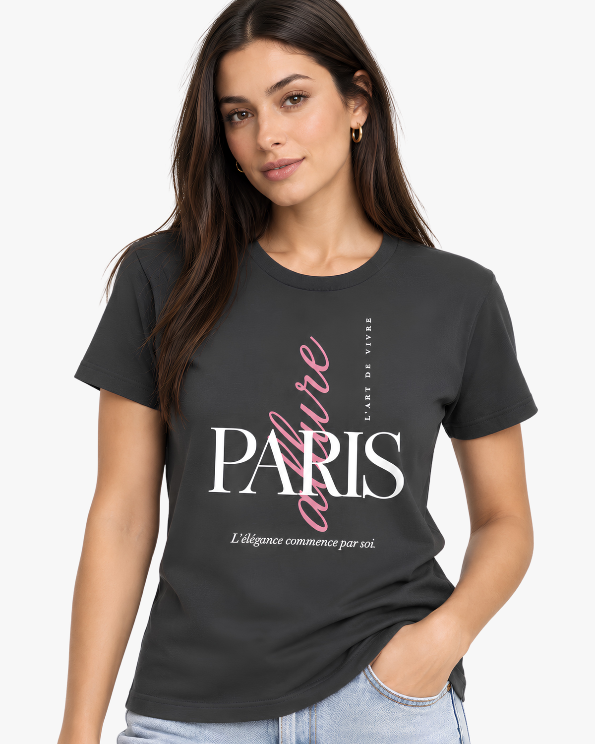 A woman wearing a dark charcoal gray graphic T-shirt with 'PARIS' in white and 'L'Esprit Vivre' in pink script, paired with light blue jeans against a plain light gray background.
