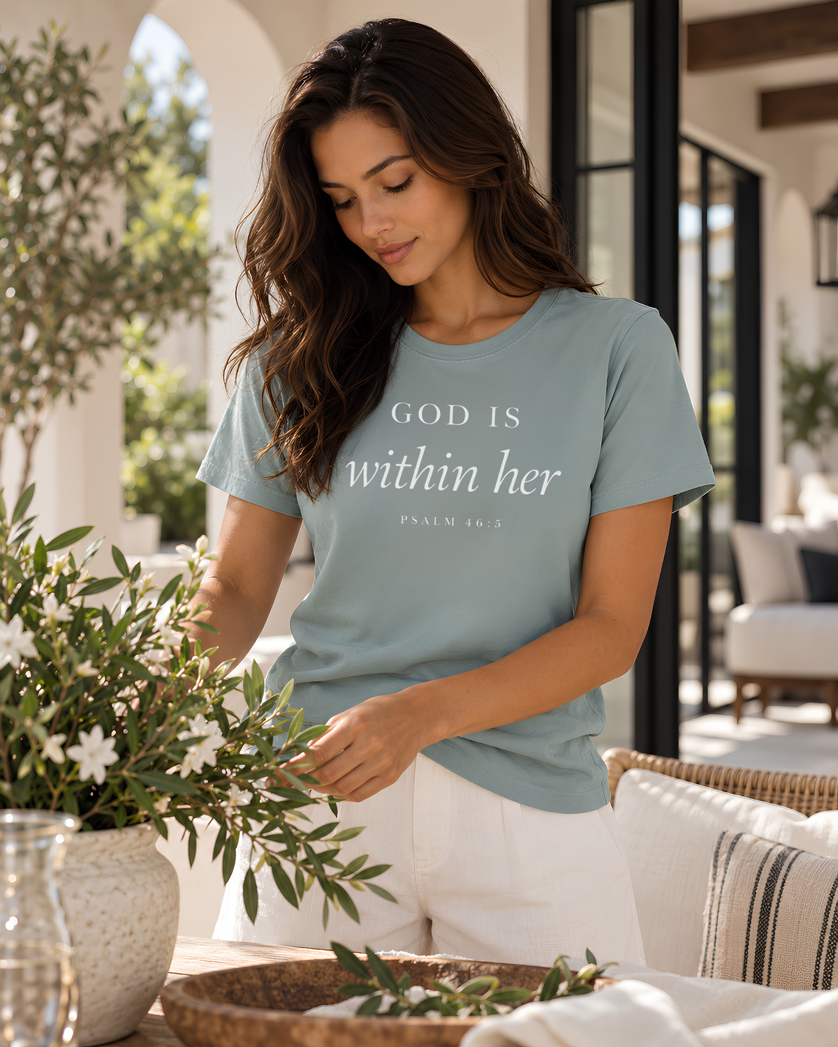 Mineral-colored God Is Within Her Psalm 46:5 women's graphic T-shirt featuring understated Christian typography.